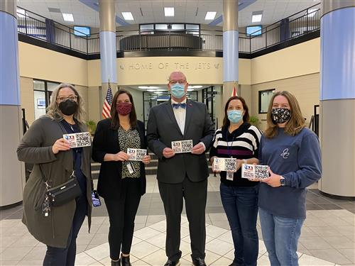 James Clemens principal with PTA leaders holding up placards